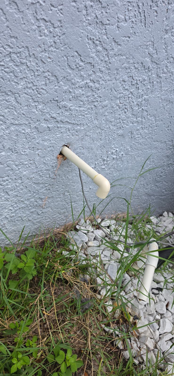 Dual PVC Pipes - Tampa, FL 33626 Two PVC pipes on exterior wall, plumbing in Tampa, FL 33626.