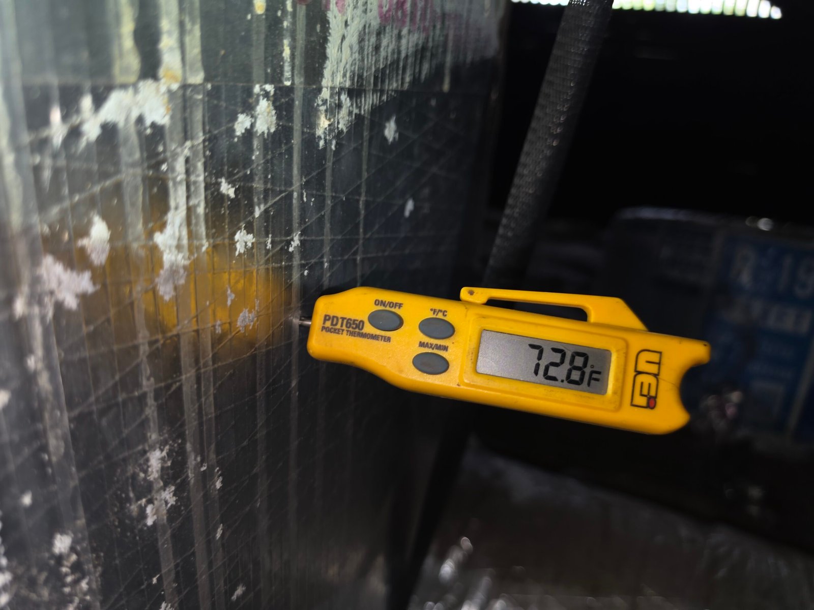 Digital thermometer showing temperature on ductwork in Tampa, FL 33605.