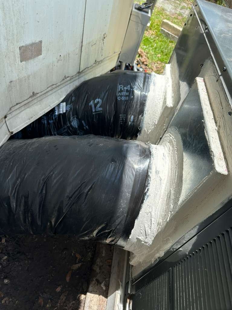 Duct work installation with black insulated ducts in Odessa, FL 33556. Efficient airflow setup.