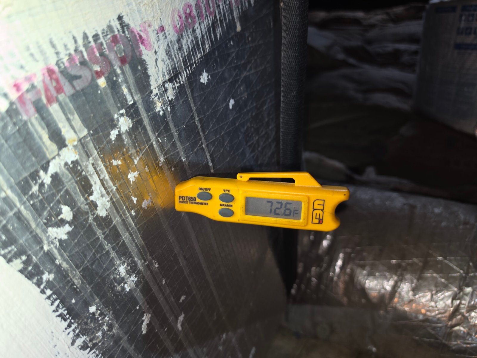 Temperature reading on ductwork with digital thermometer in Tampa, FL 33605.