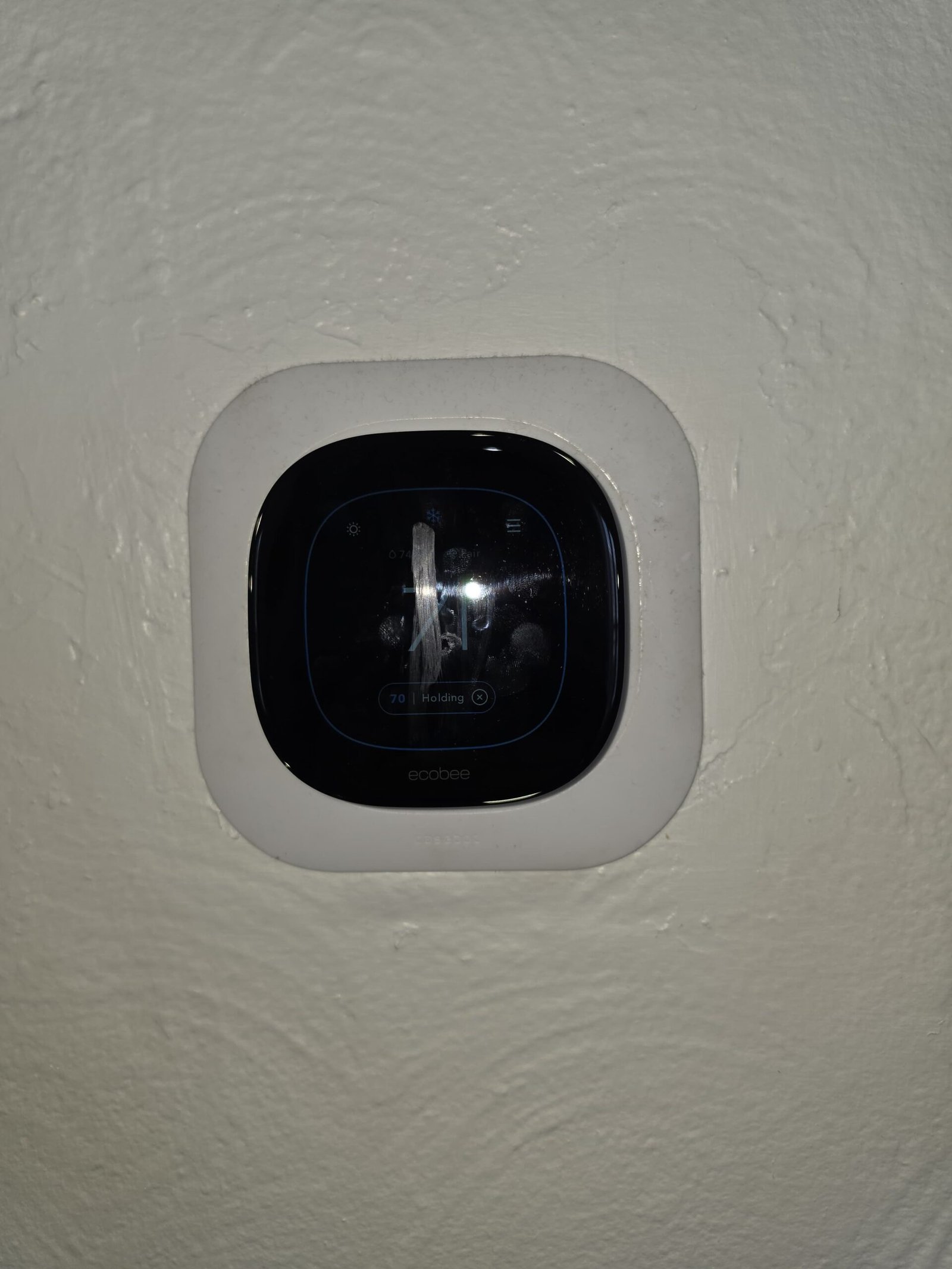 Ecobee smart thermostat mounted on wall for HVAC control in Tampa, FL 33605.