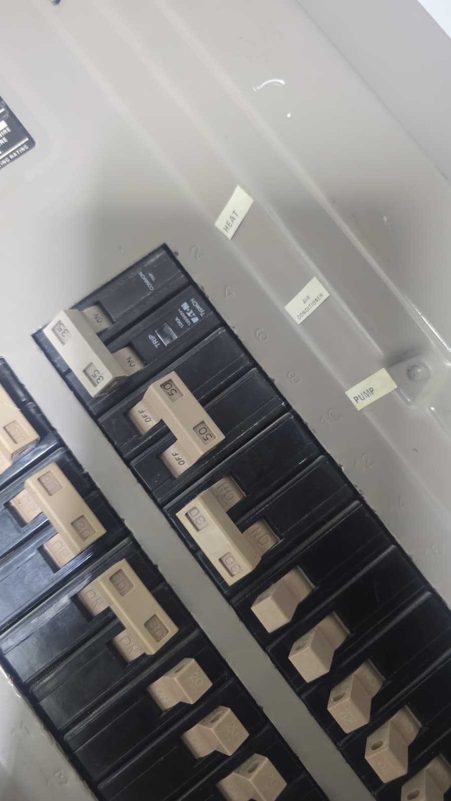 Close-up of labeled electrical panel with breakers in Riverview, FL 33579. Detail of AC system components.