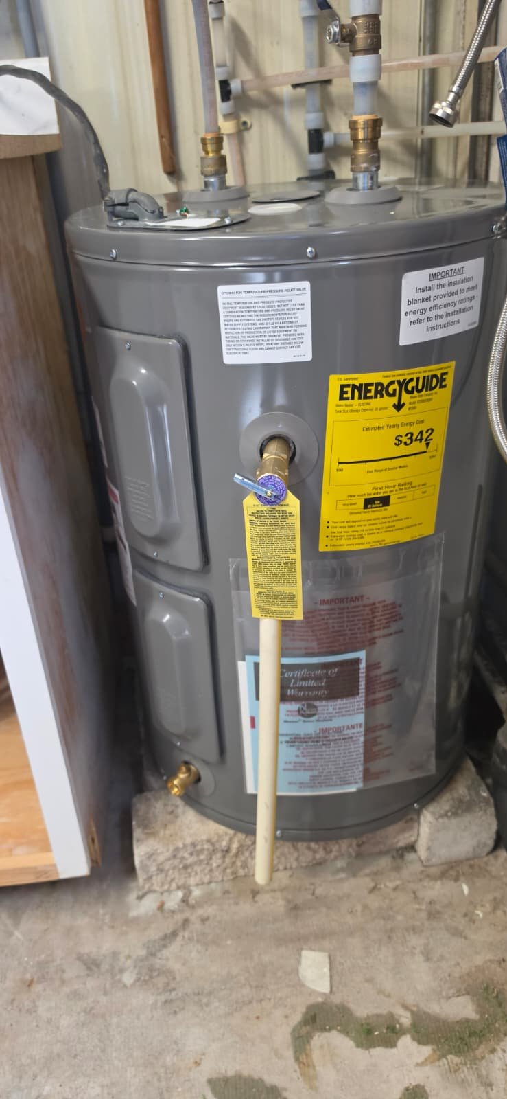 Close-up of new water heater with energy guide in Port Richey, FL 34668. Energy-efficient choice.