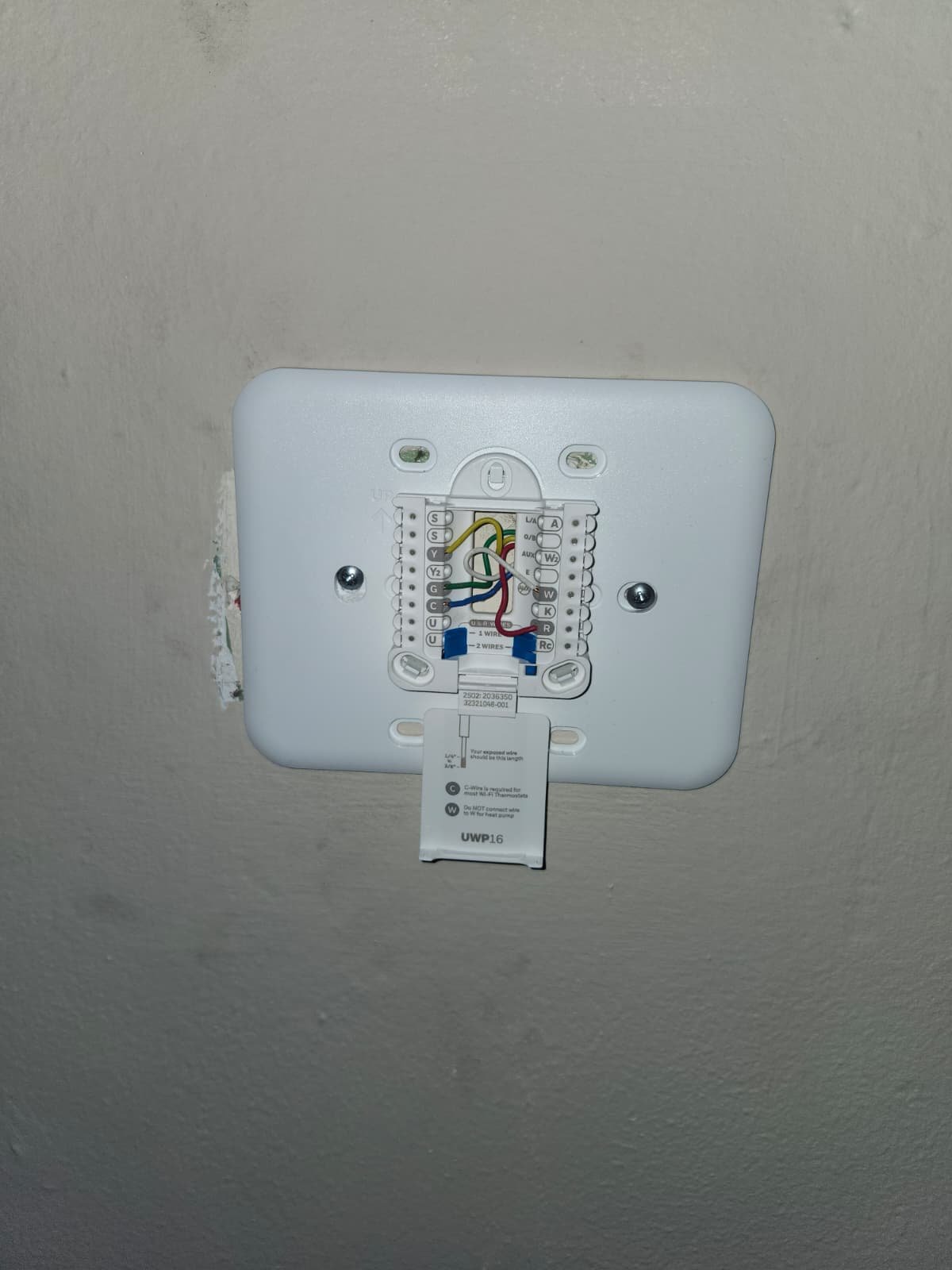 Thermostat wiring exposed on wall in Tampa, FL 33607.