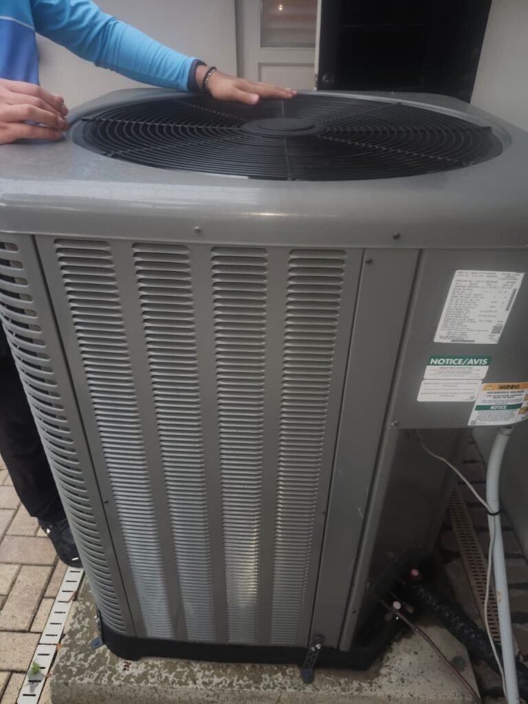 Exterior HVAC Unit View in Clearwater, FL 33764 Exterior view of HVAC unit with technician in Clearwater, FL 33764