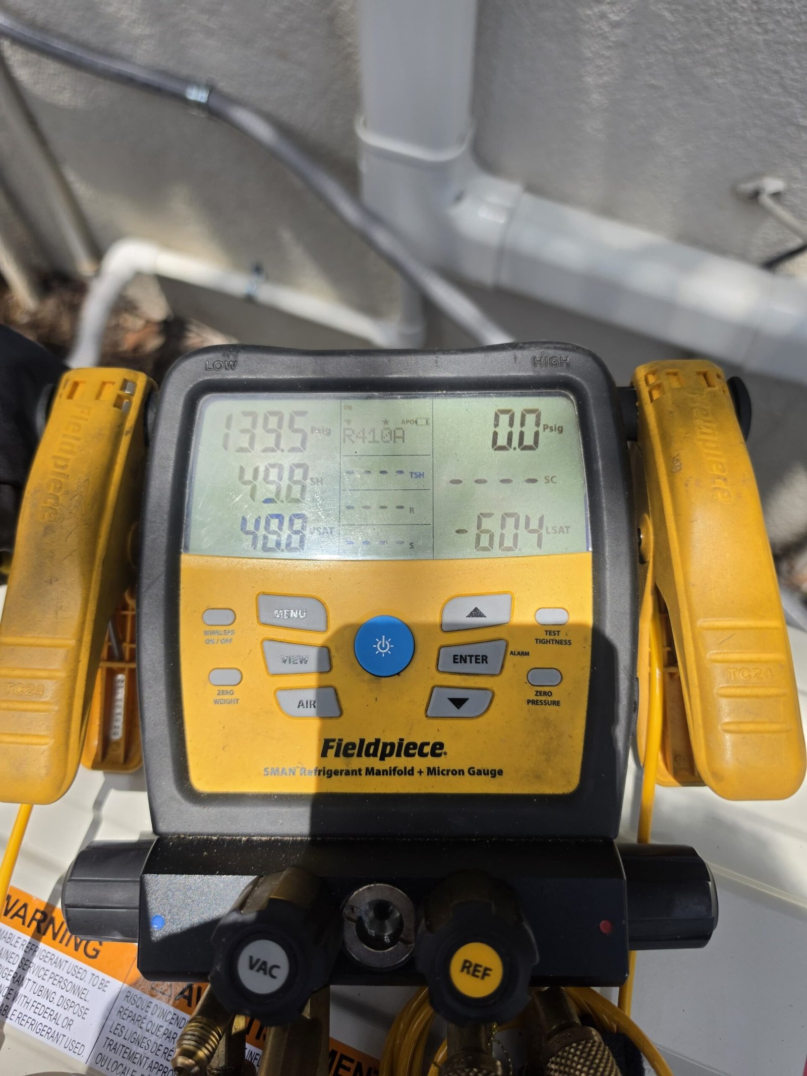 Fieldpiece digital manifold gauge displaying HVAC readings, Lutz, FL 33558.