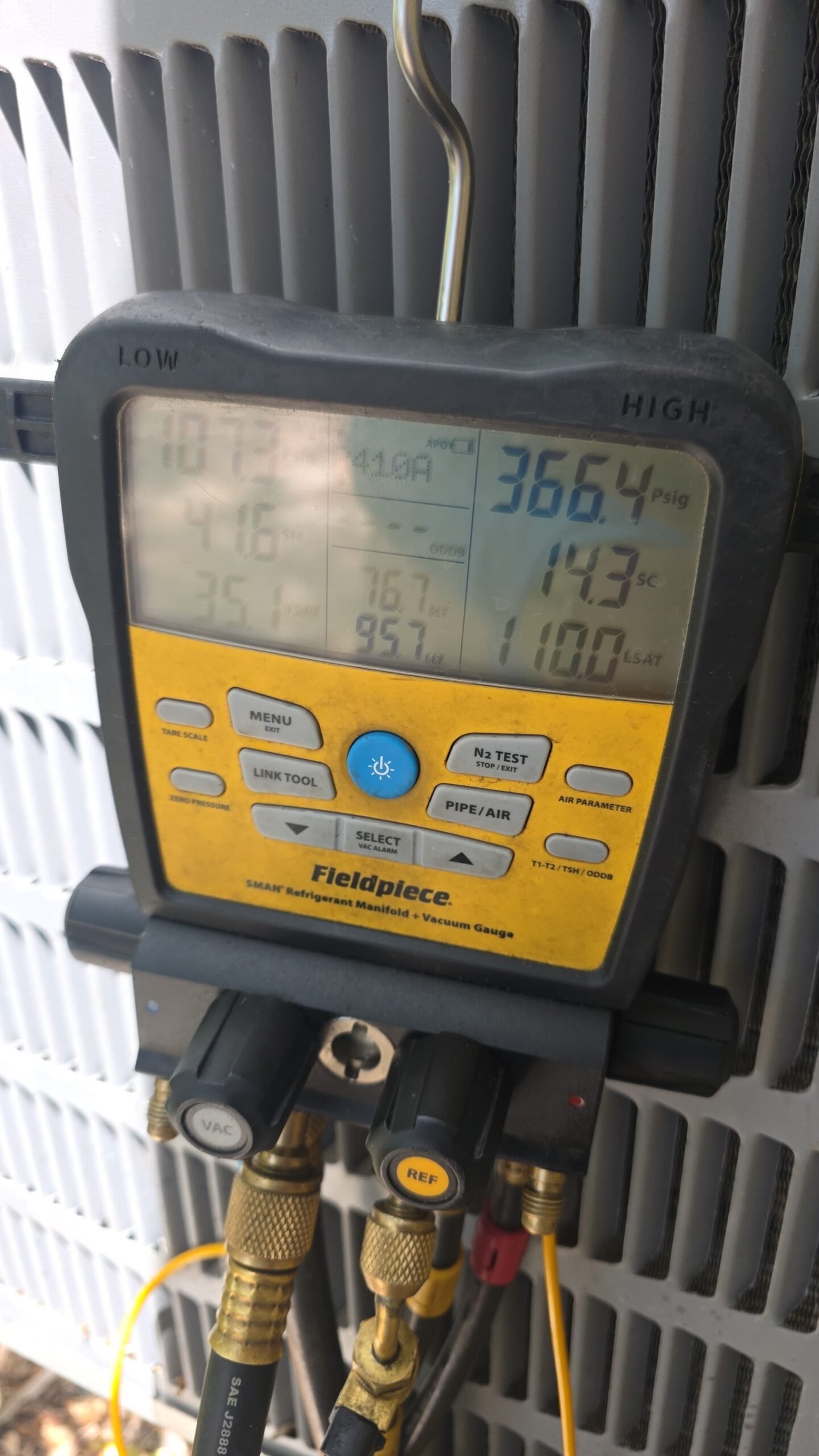 Fieldpiece digital manifold gauge attached to an AC unit, Tampa, FL 33606.