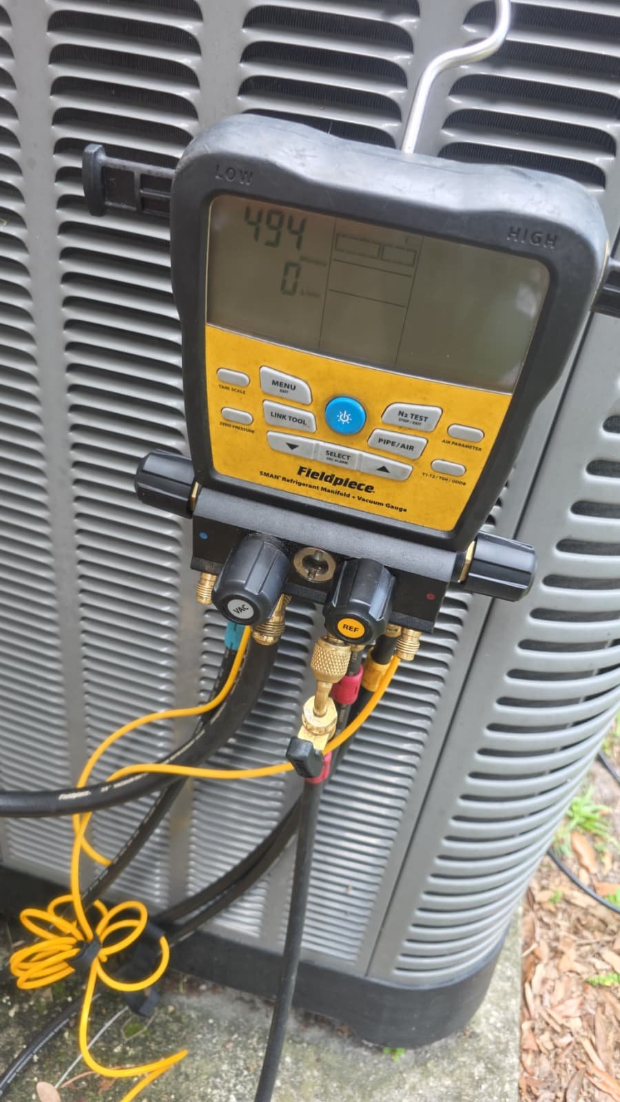 Fieldpiece Gauge with Hoses - New Port Richey, FL 34655 Fieldpiece manifold gauge with hoses connected to AC unit in New Port Richey, FL 34655.