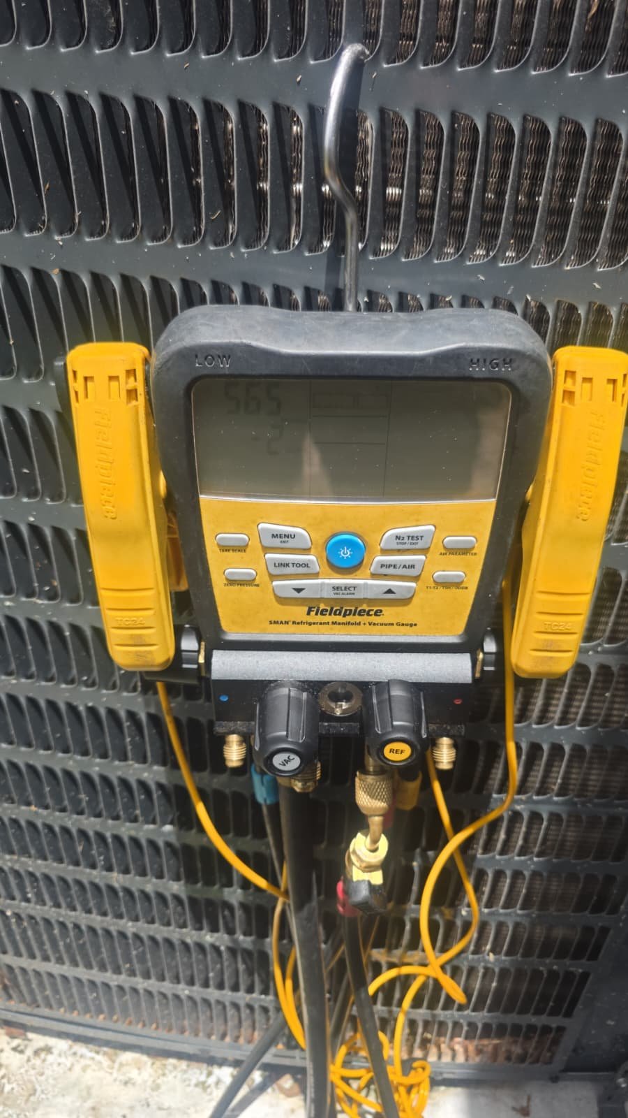 Fieldpiece HVAC gauge attached to an AC unit in Riverview, FL 33579. Equipment used for system repair.