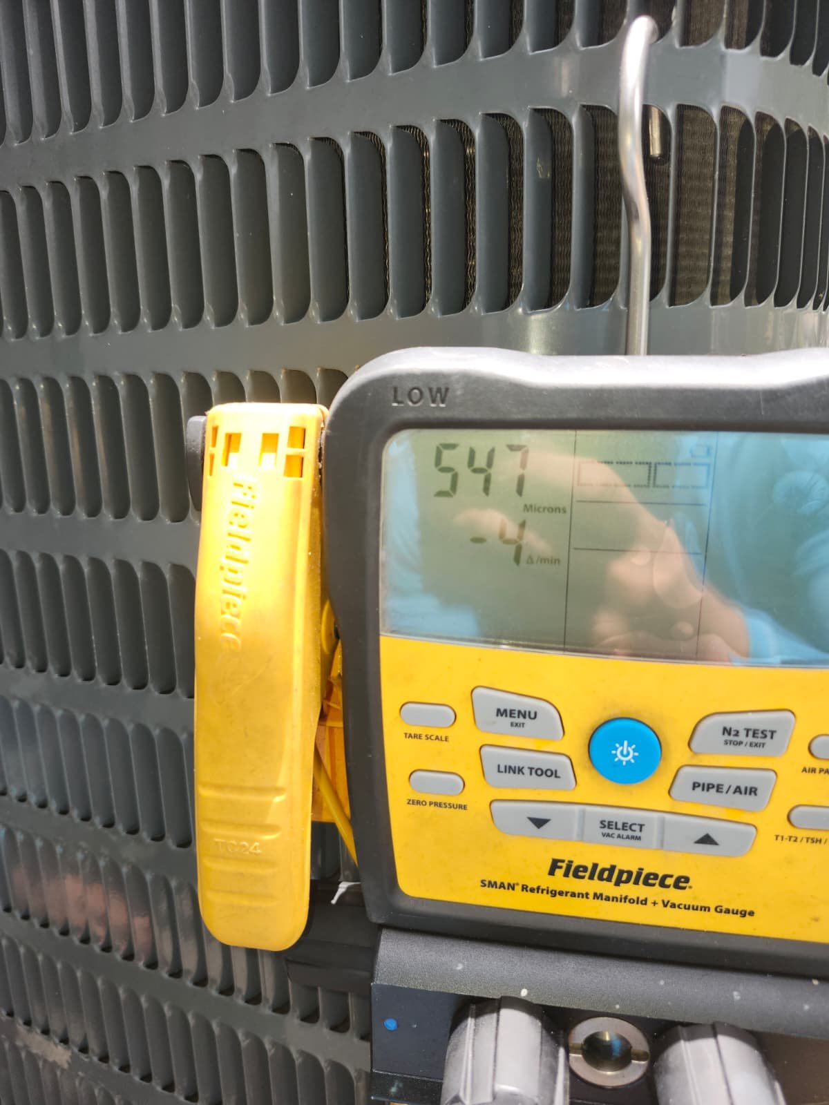 Fieldpiece vacuum gauge attached to AC unit in Tampa, FL 33607.