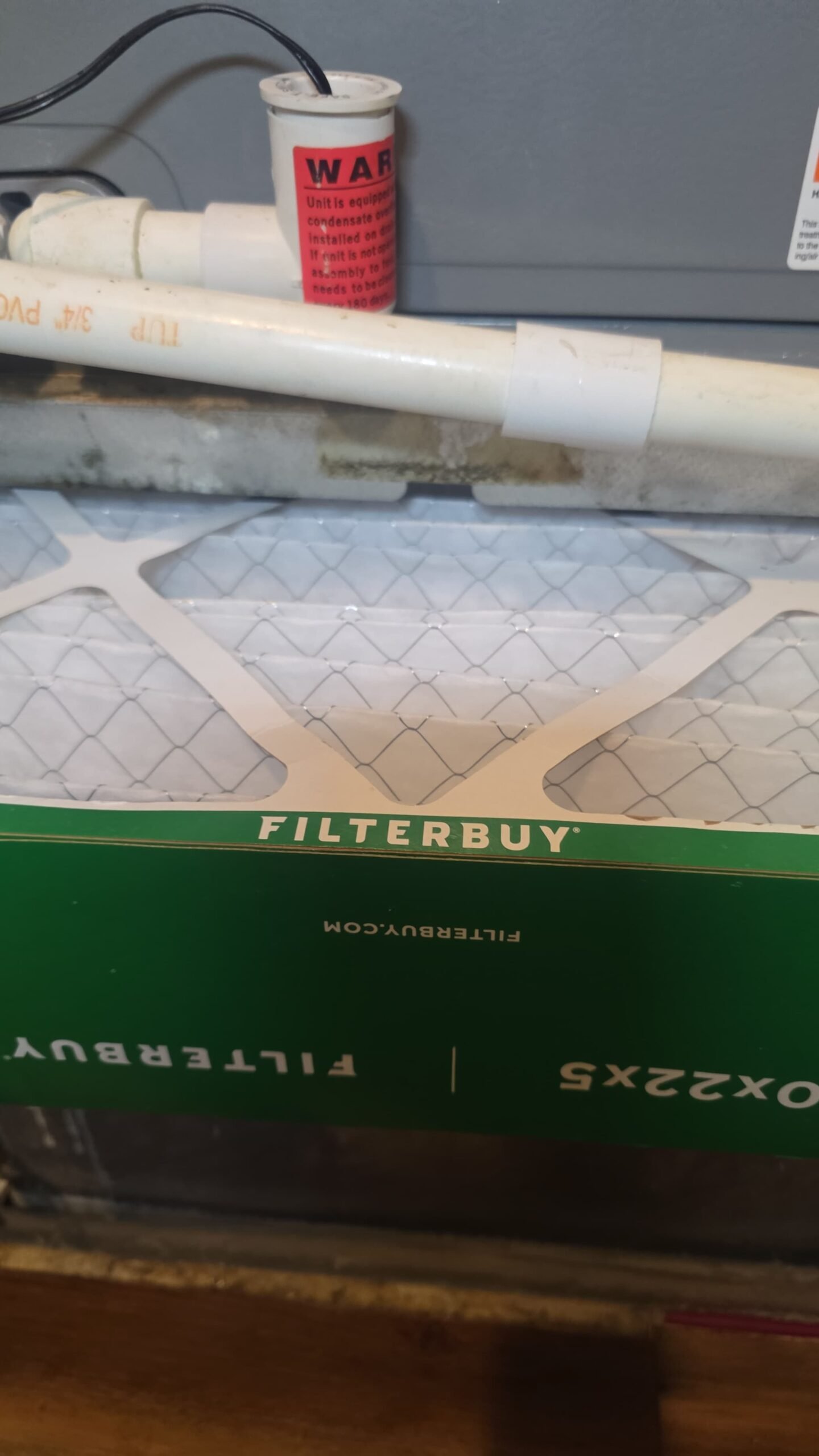 Close-up of Filterbuy air filter in HVAC system during Elite Therapy Plan in Bradenton, FL 34202.