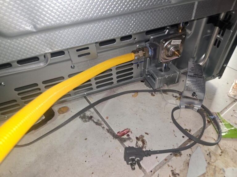 Gas line connected to appliance with messy floor in Tampa, FL 33611