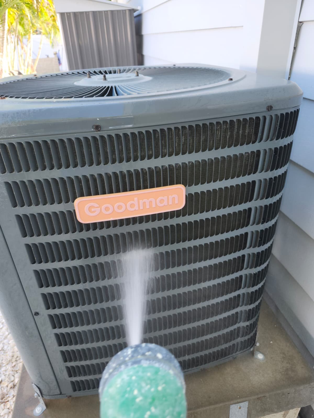 Goodman AC unit cleaning with hose, St. Petersburg, FL 33703.