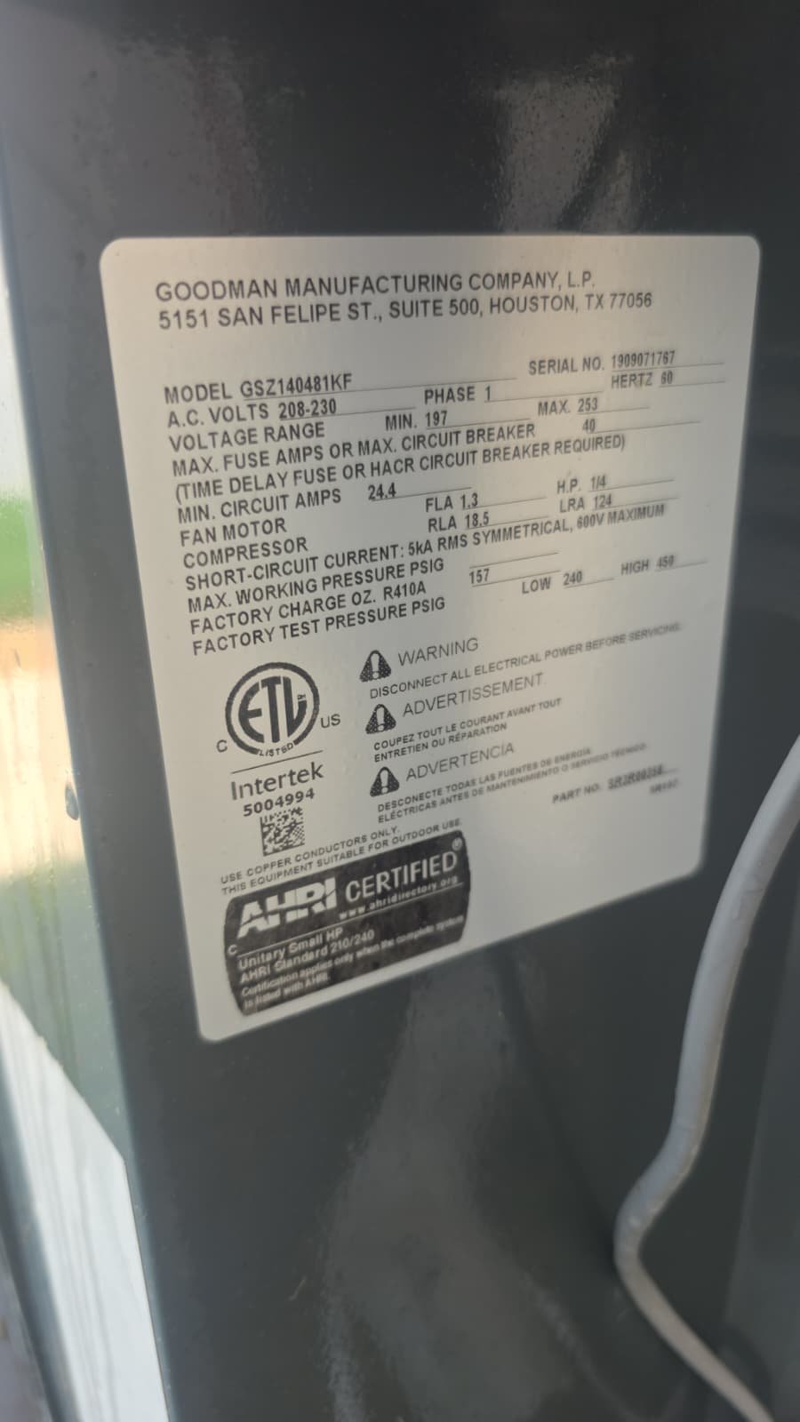 Close-up of Goodman AC unit label with specifications, Tampa, FL 33618.
