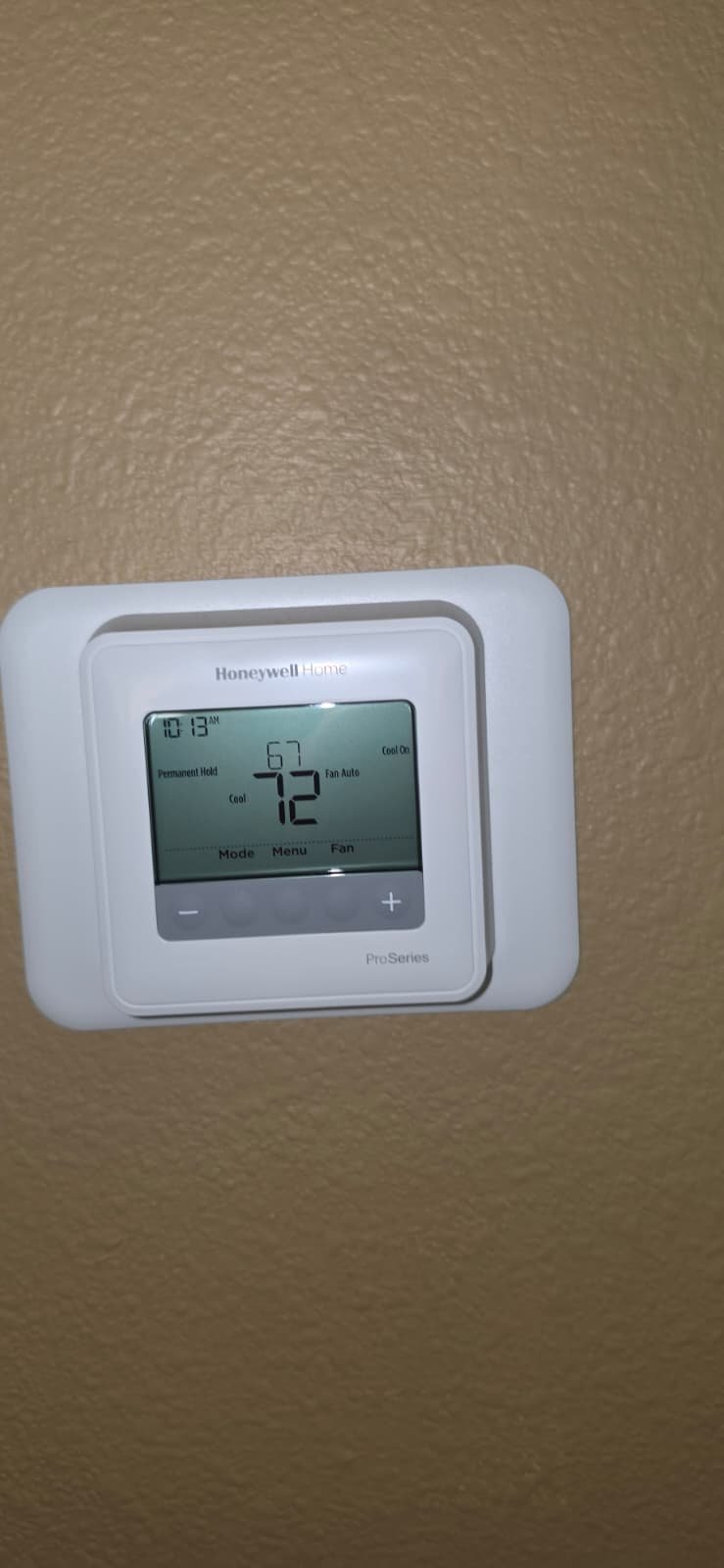 Close-up of a Honeywell thermostat on a wall in Lutz, FL 33559.