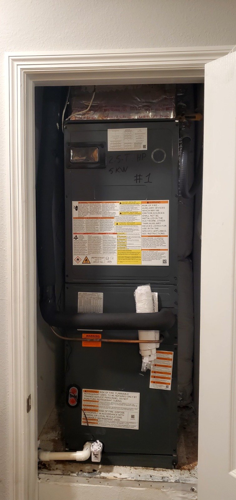 HVAC unit installed in closet with labels in Tampa, FL 33616.