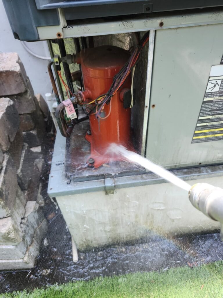 Water spray on HVAC components during cleaning in Tampa, FL 33609