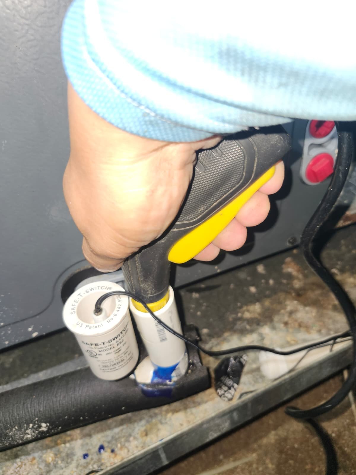 Technician with tool near HVAC components, St. Petersburg, FL 33703.