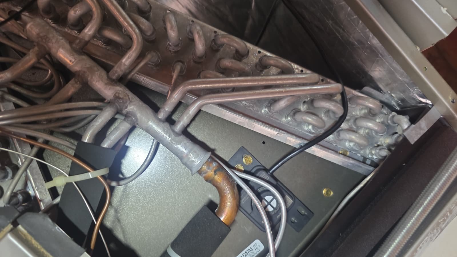 Close-up of HVAC system components showing coils and wiring in Largo, FL 33771.
