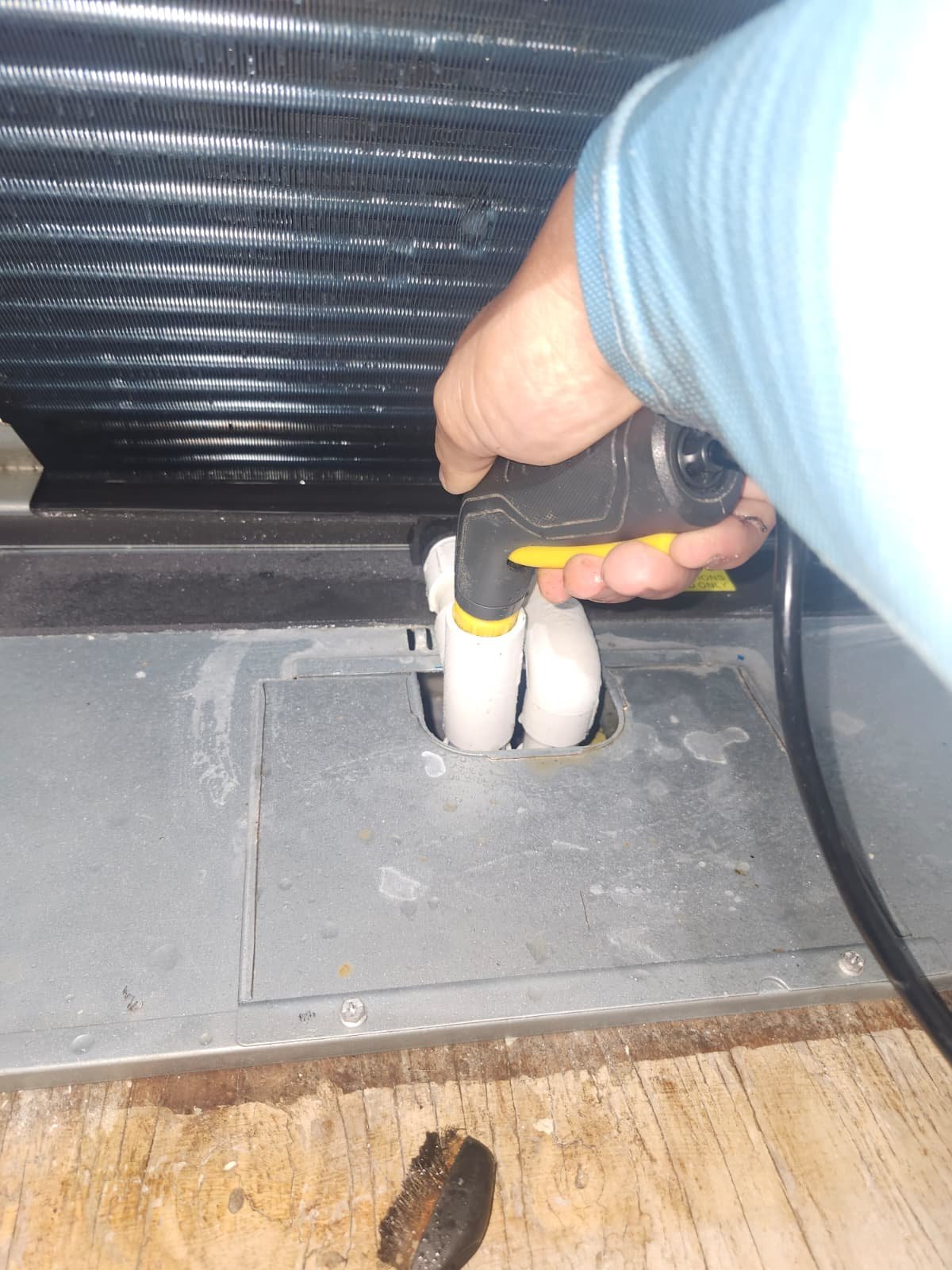 HVAC Drainage Area Cleaning in Tarpon Springs, FL 34688 Spraying water inside HVAC unit near drainage area in Tarpon Springs, FL 34688. Thorough HVAC service.