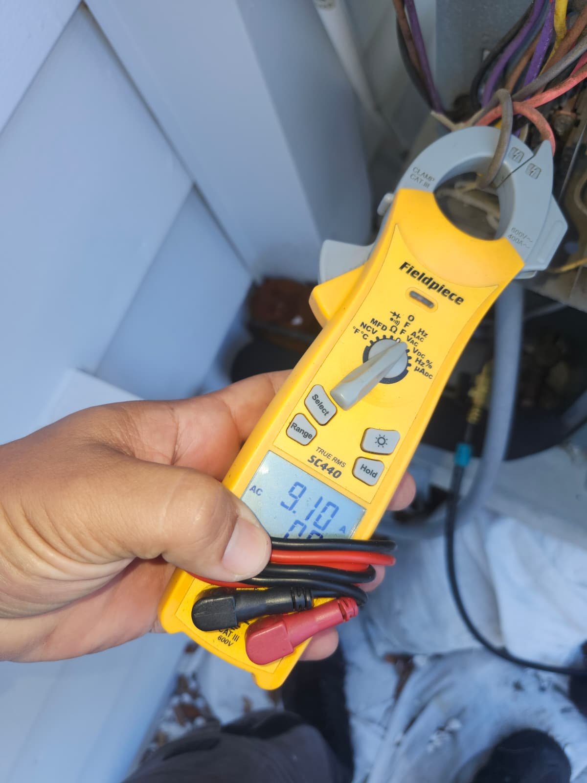 Technician checks HVAC electrical readings in St. Petersburg, FL 33703.