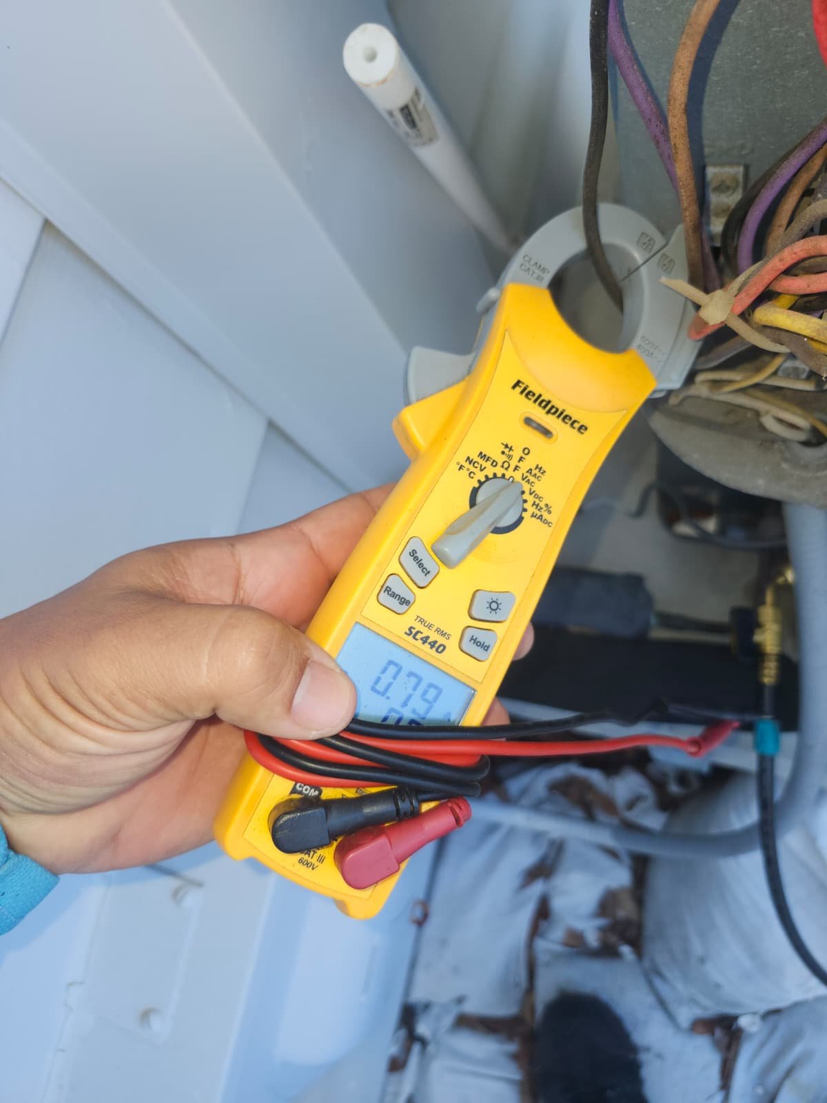 Multimeter checks HVAC electrical connections, St. Petersburg, FL 33703.