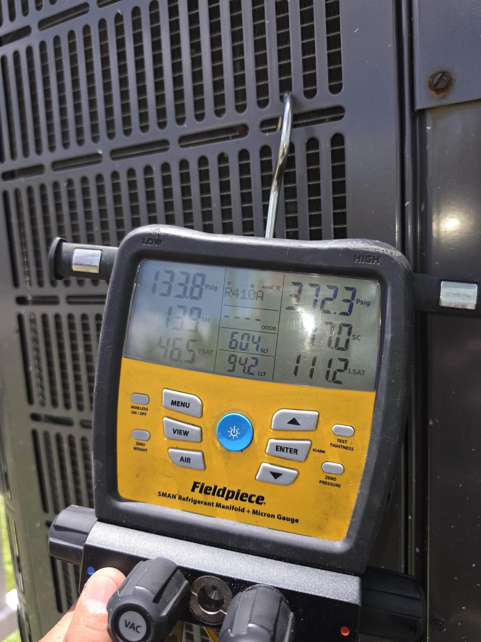 Fieldpiece manifold gauge showing pressure readings for HVAC service in Tampa, FL 33605.