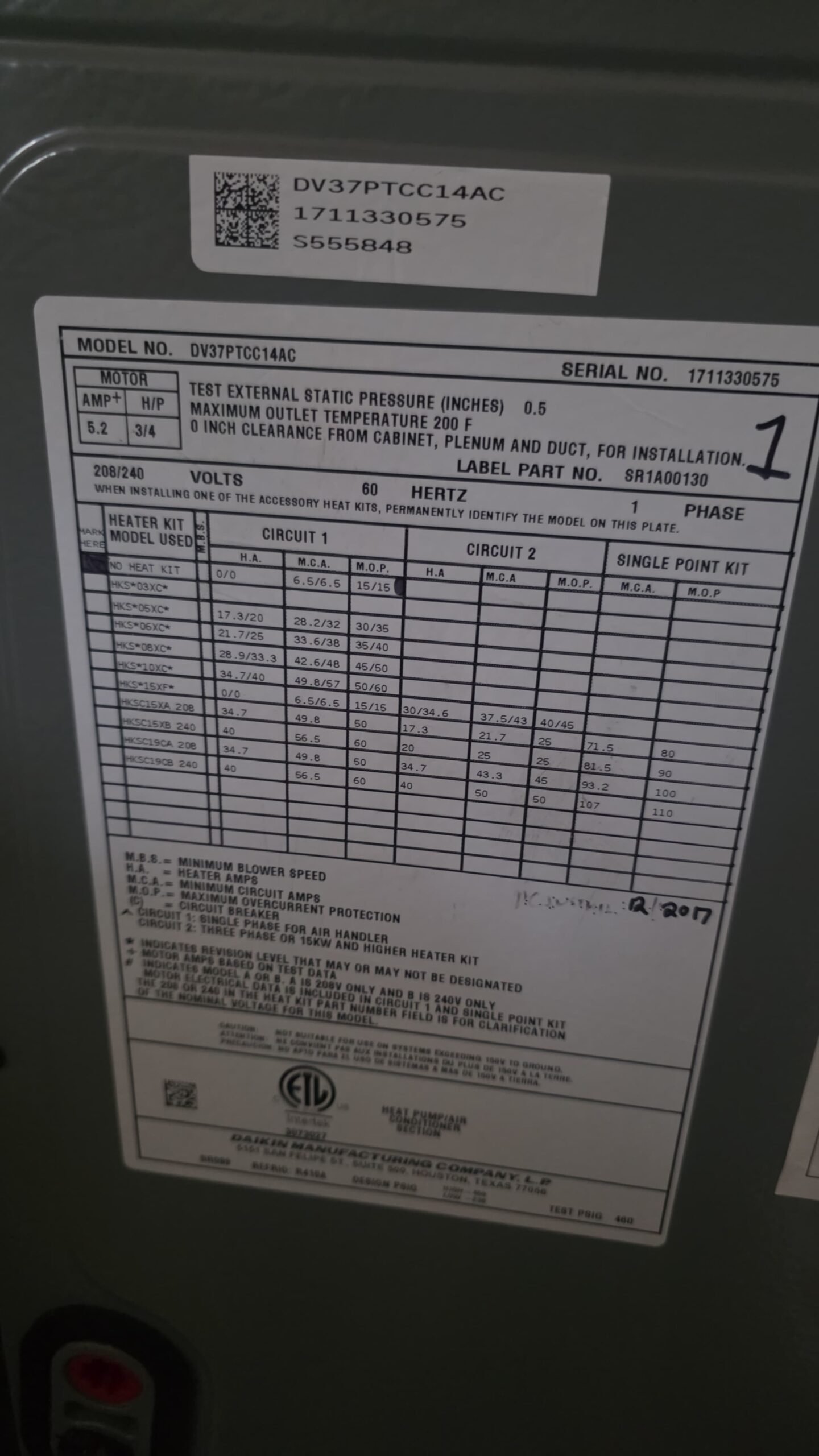 Close-up of HVAC unit label showing specifications during Elite Therapy Plan in Bradenton, FL 34202.