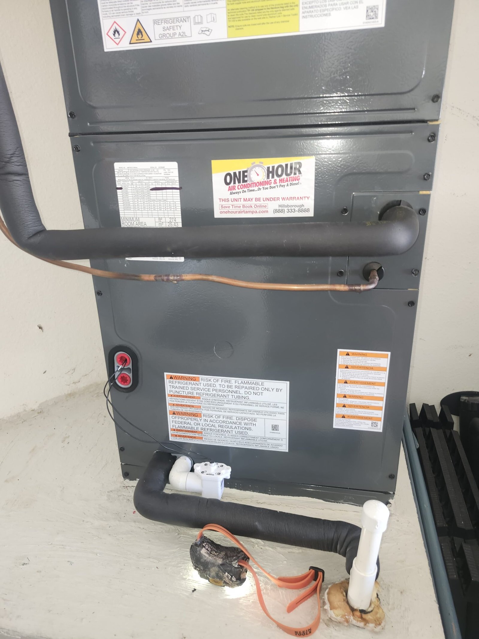 Lower section of HVAC unit showing pipes, free diagnosis in Brandon, FL 33511.