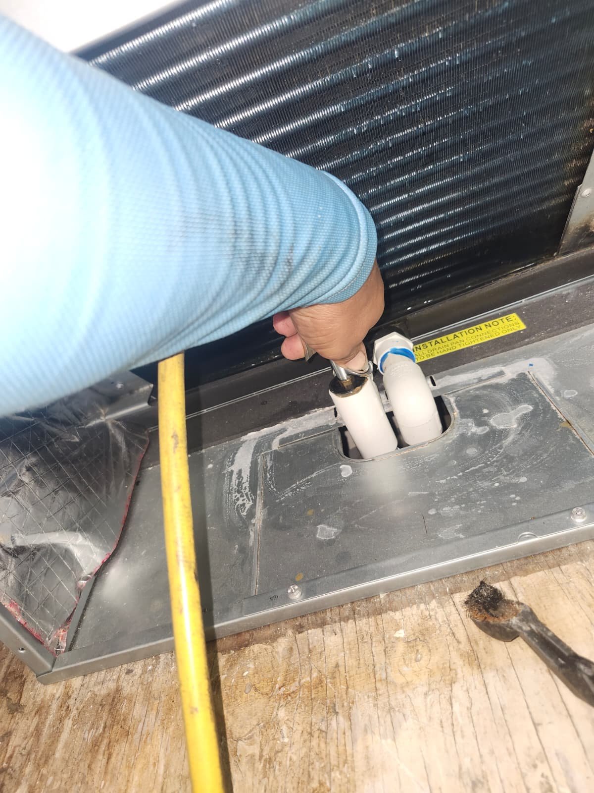 HVAC Piping Work in Tarpon Springs, FL 34688 Technician working on HVAC piping and connections indoors in Tarpon Springs, FL 34688. Expert HVAC service.