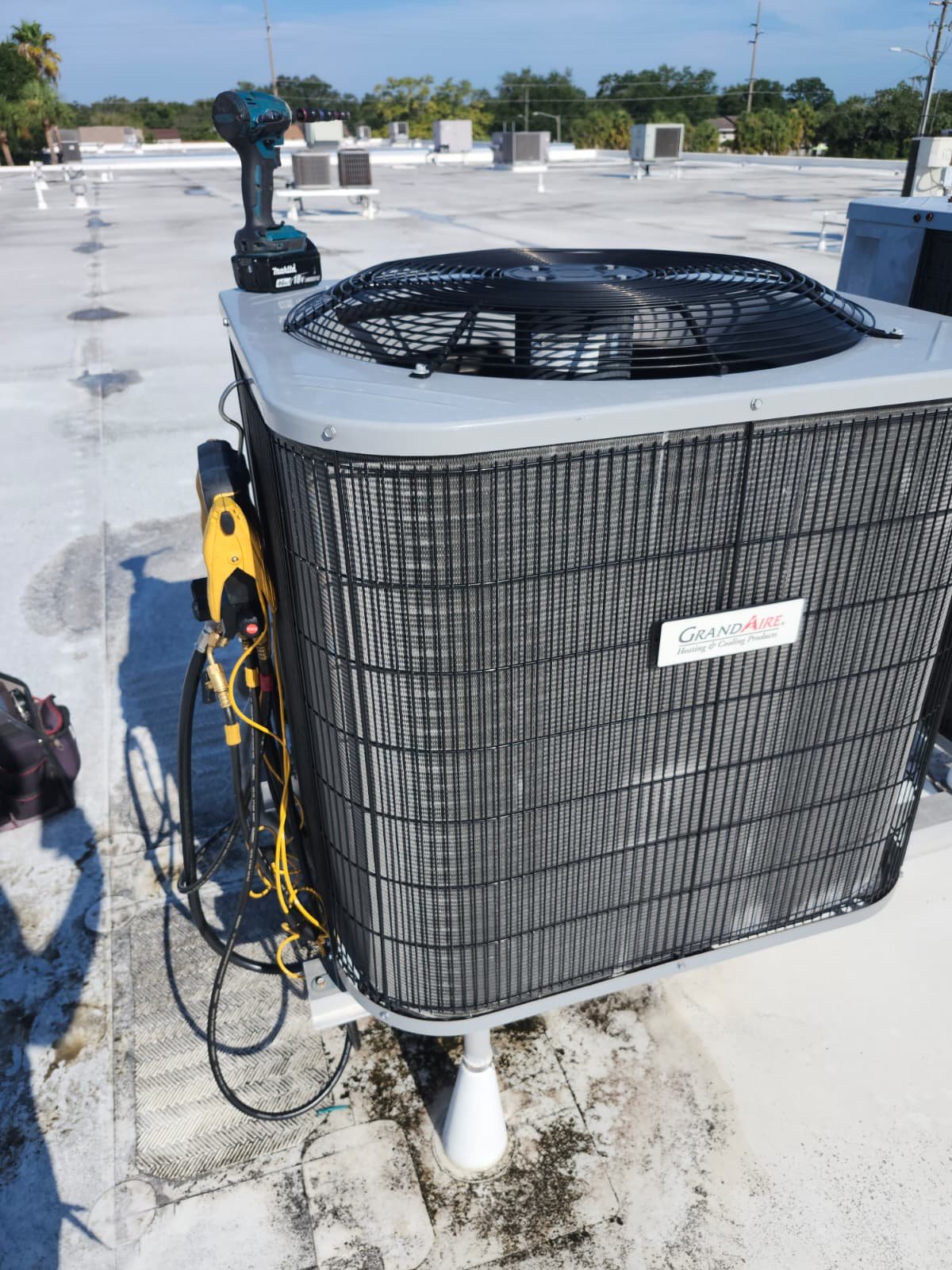 HVAC unit on rooftop with tools during maintenance in Tampa, FL 33634.