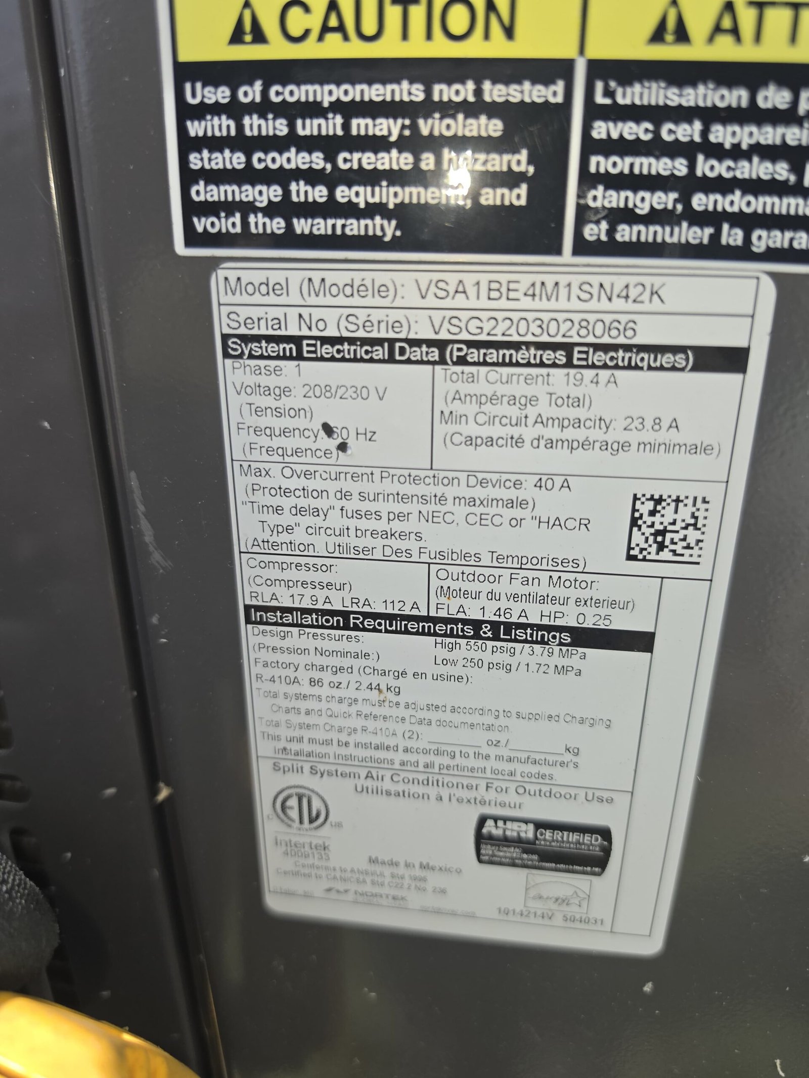 Close-up of AC unit specifications label for HVAC service in Tampa, FL 33605.