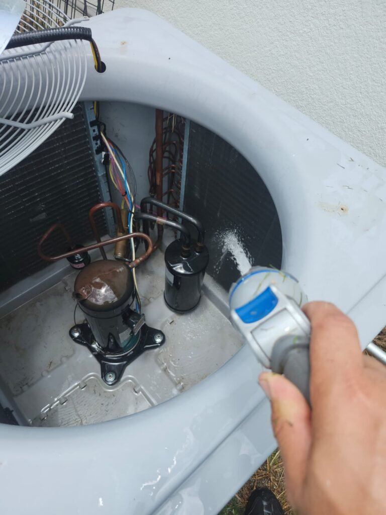 HVAC Unit Cleaning in Land O' Lakes, FL 34637 Technician cleaning HVAC unit during service in Land O' Lakes, FL 34637