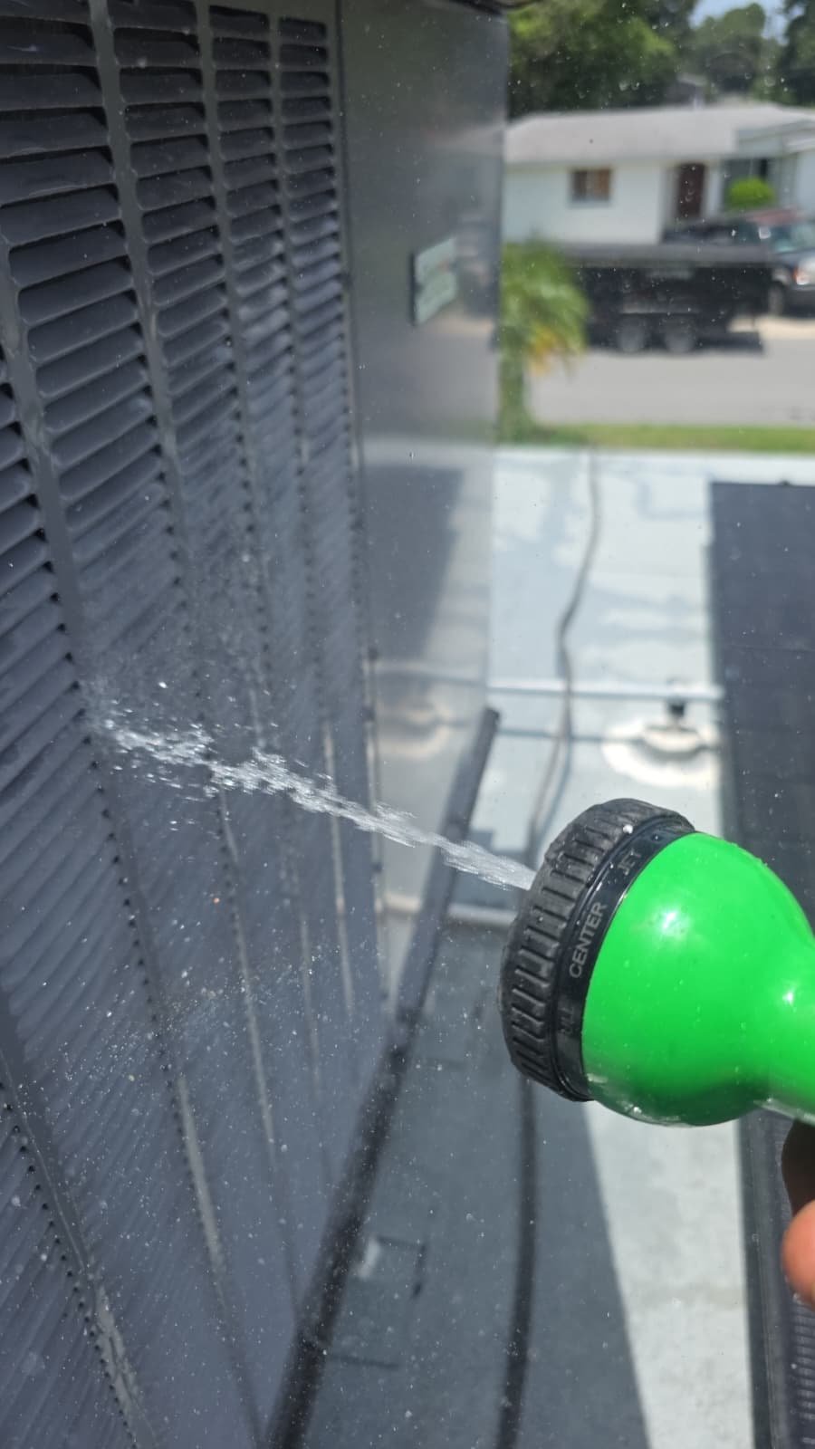 HVAC Unit Cleaning Process - Largo, FL 33773 Cleaning HVAC unit with water hose in Largo, FL 33773.
