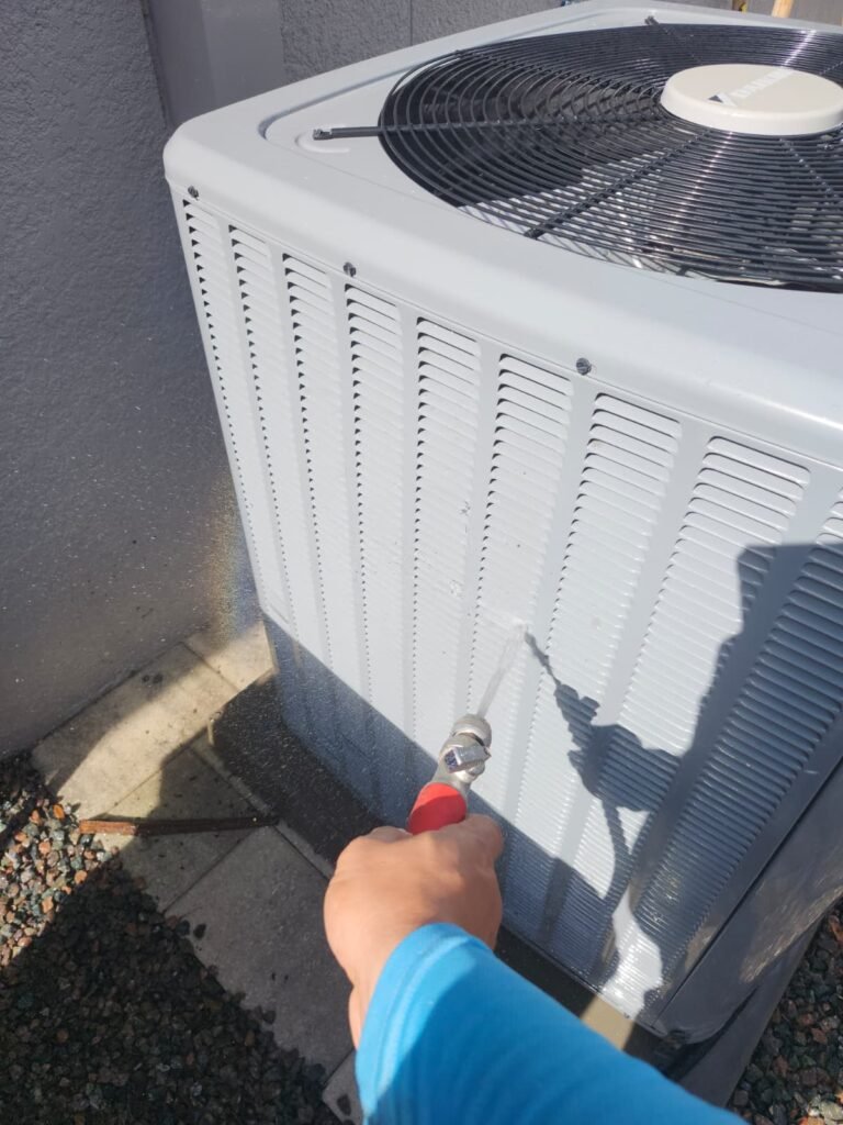 HVAC Unit Cleaning in Largo, FL 33774 Technician cleaning HVAC unit in Largo, FL 33774