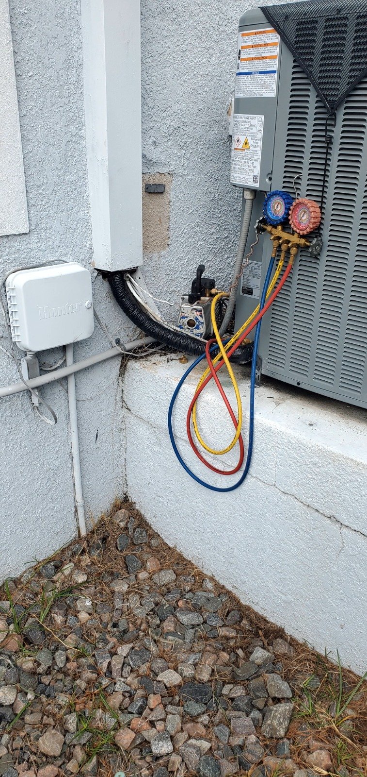 Exterior view of HVAC unit with gauges in Tampa, FL 33616.