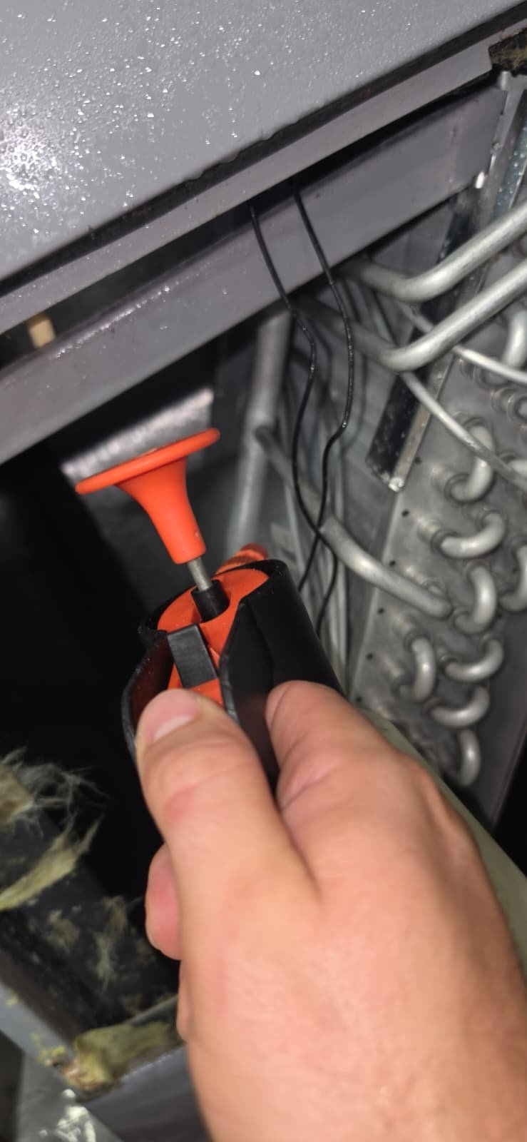 Technician working on HVAC wiring in Lutz, FL 33559 during Visit #4.