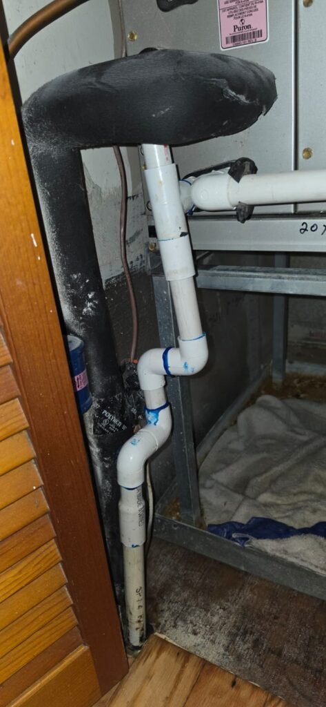 The PVC condensate drain line at an indoor air handler in Tampa, FL 33617.