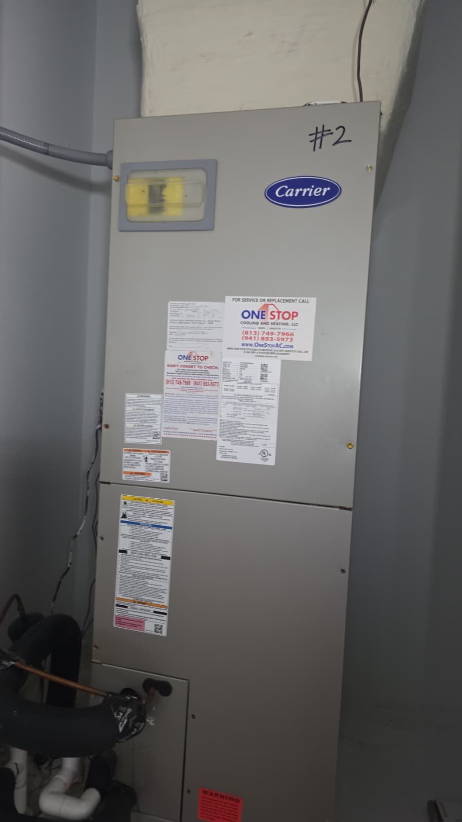 Indoor HVAC Unit - Tampa, FL 33611 Indoor HVAC unit with brand and service stickers, Tampa, FL 33611.