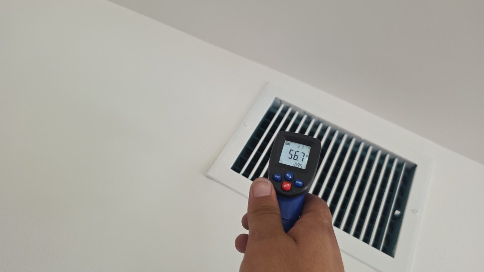 Infrared thermometer reading temperature at vent, Tampa, FL 33606.