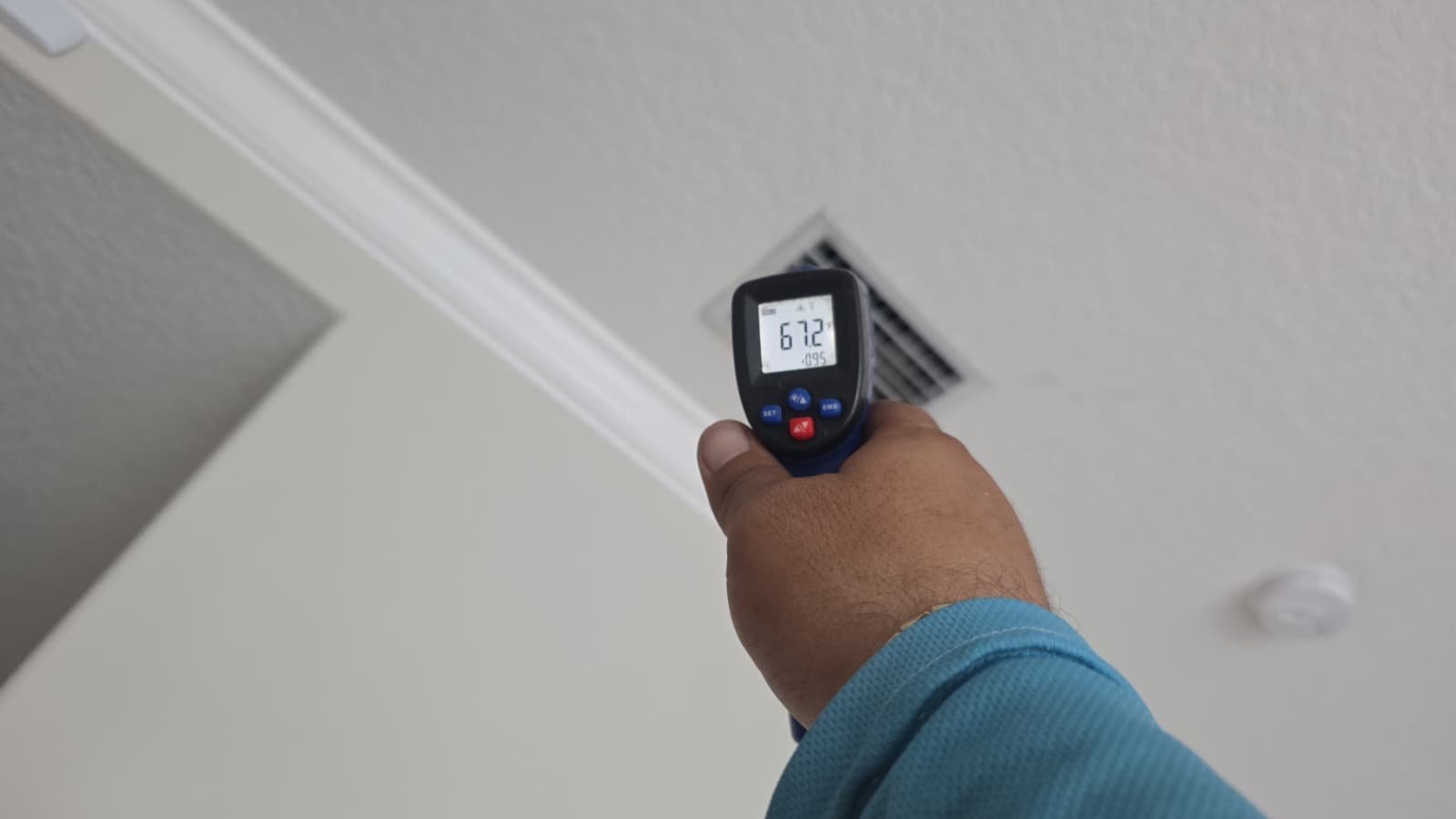 Measuring Air Vent Output - Tarpon Springs, FL 34688 Person using a temperature gun to measure air vent output in Tarpon Springs, FL 34688. Ensuring optimal performance.