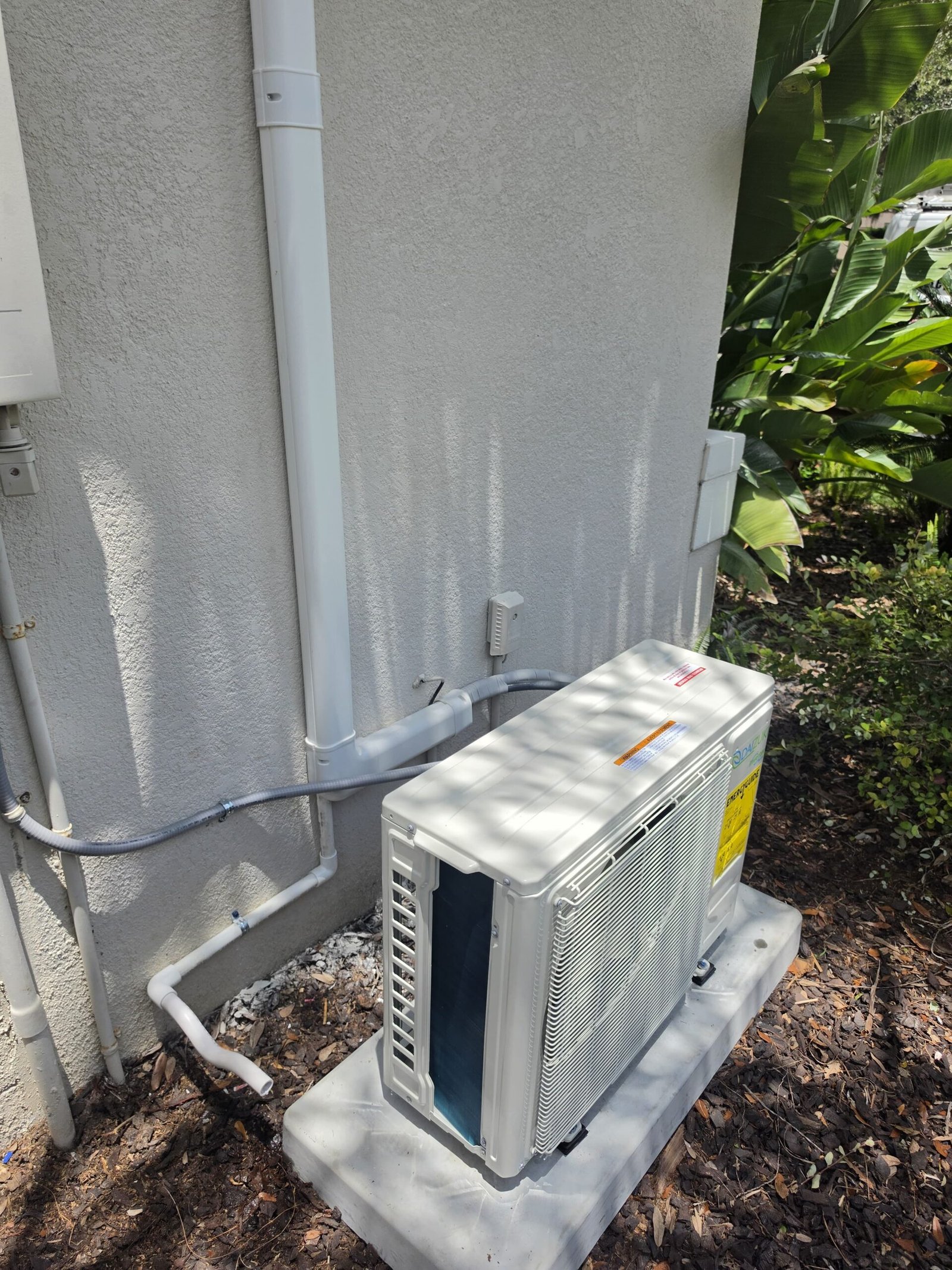 Installed mini split AC outdoor unit beside house, Lutz, FL 33558.