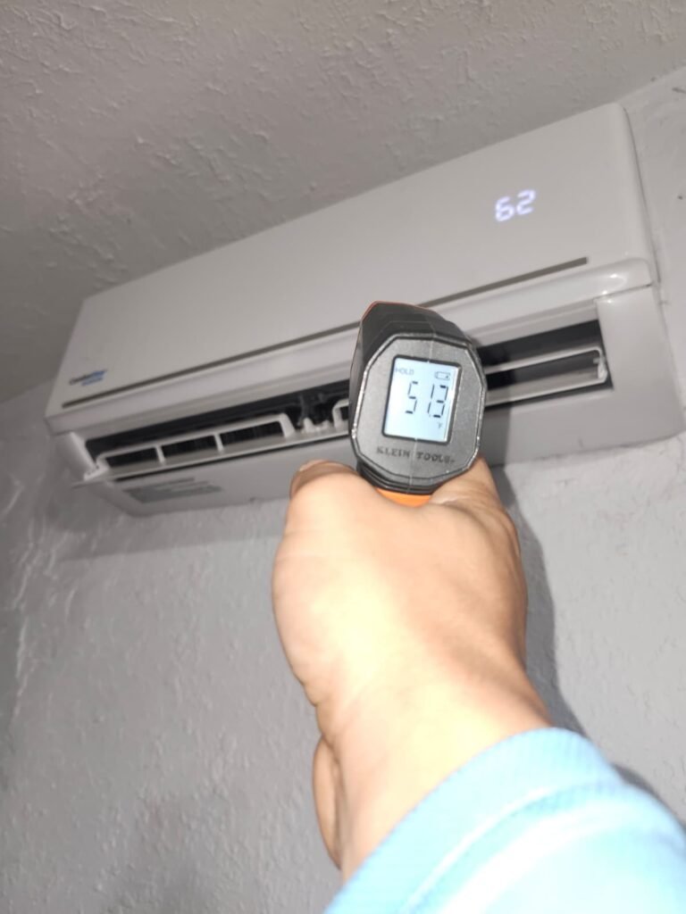 Checking a mini-split’s air temperature on a service call in Tampa, FL 33617.