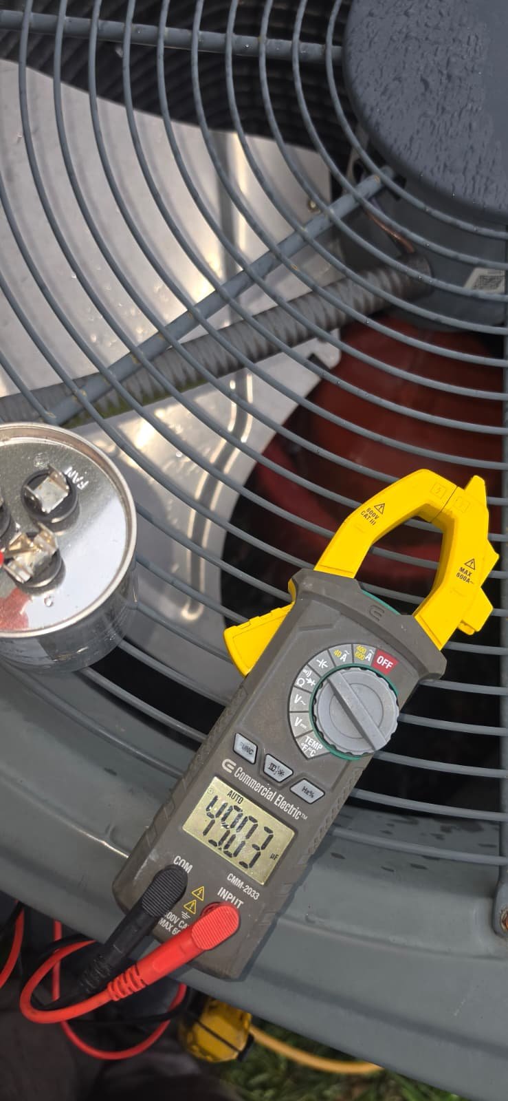 Close-up of multimeter reading on AC unit in Wesley Chapel, FL 33545. Precision HVAC diagnostics.