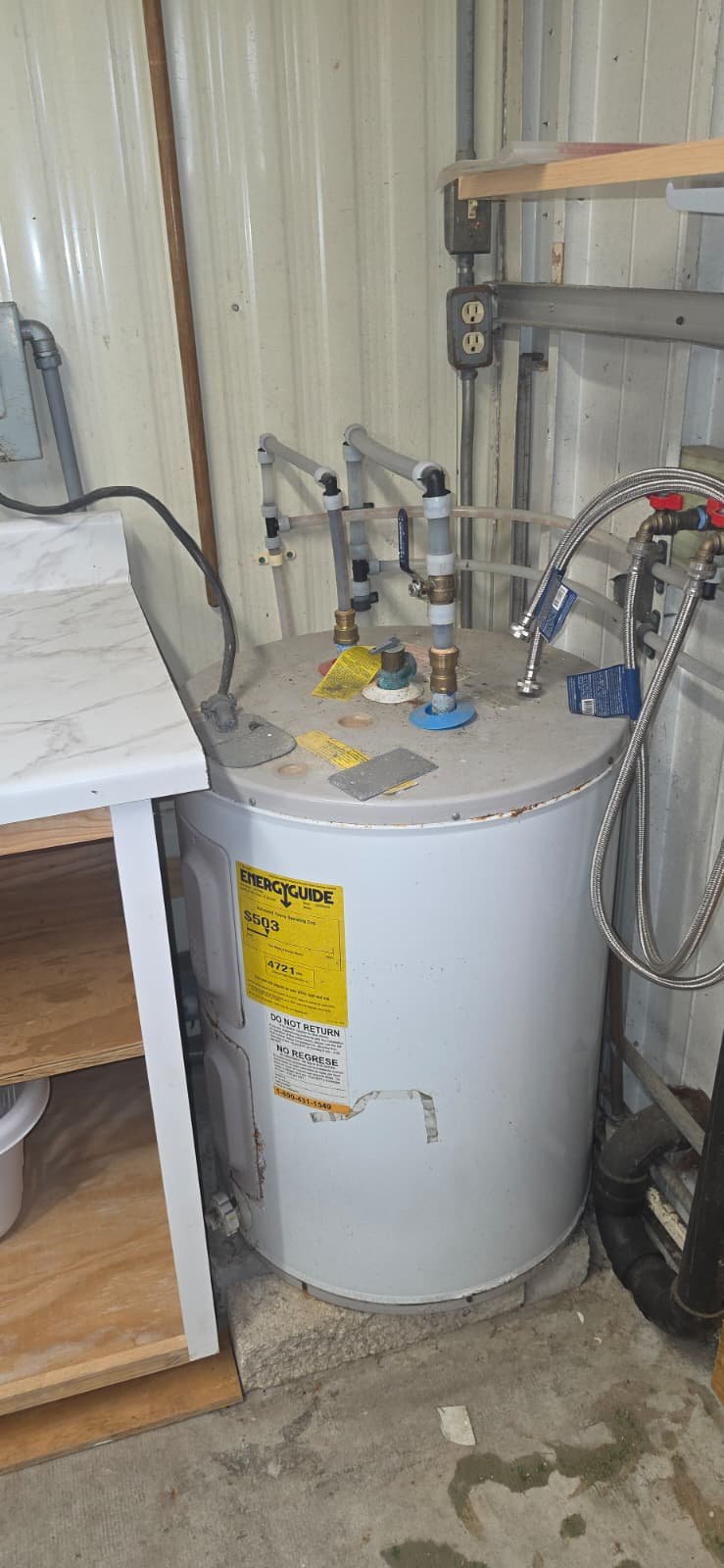 Old water heater in utility room, Port Richey, FL 34668. Before replacement.