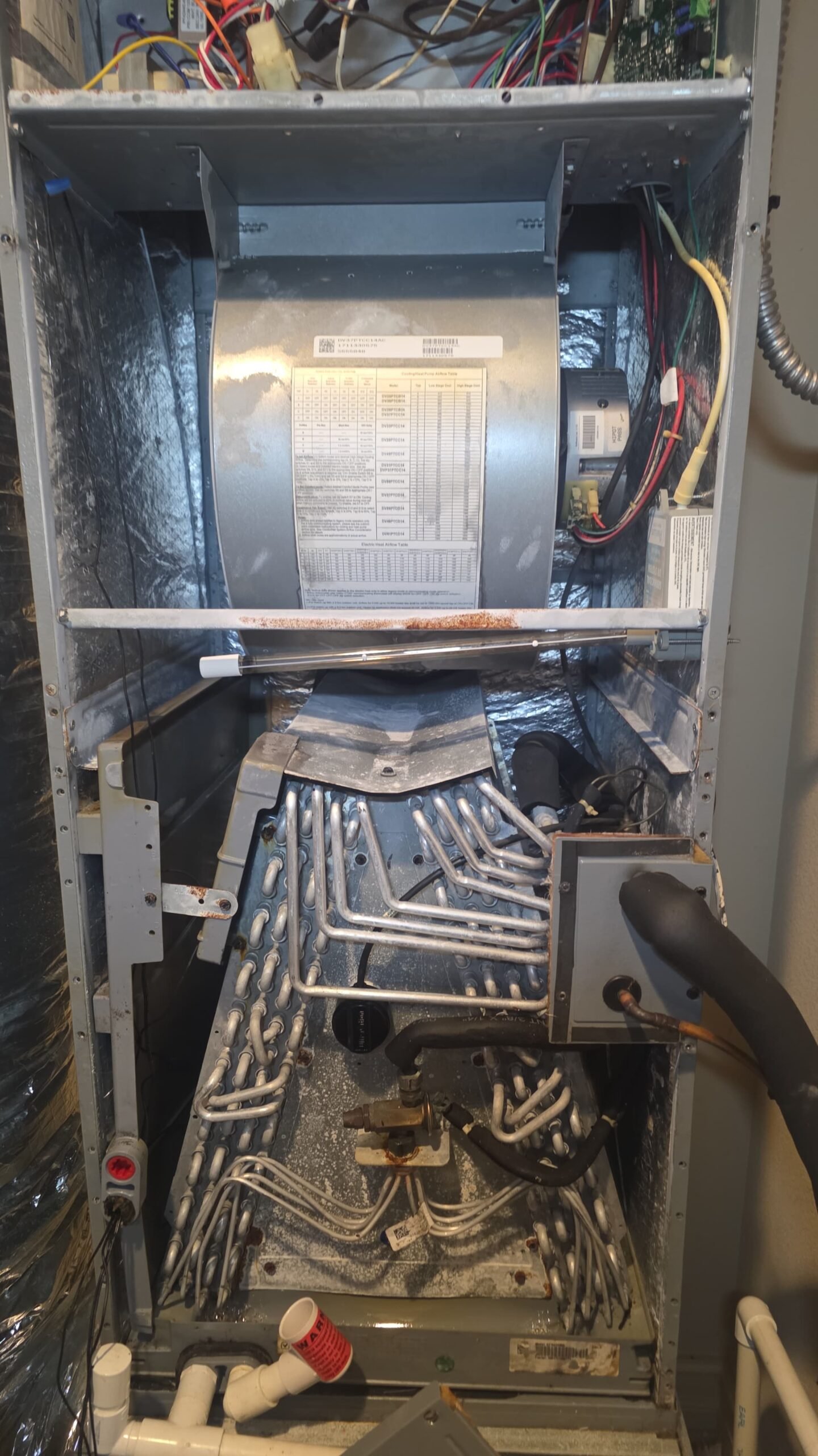 Open HVAC unit showing components and wiring, part of Elite Therapy Plan in Bradenton, FL 34202.