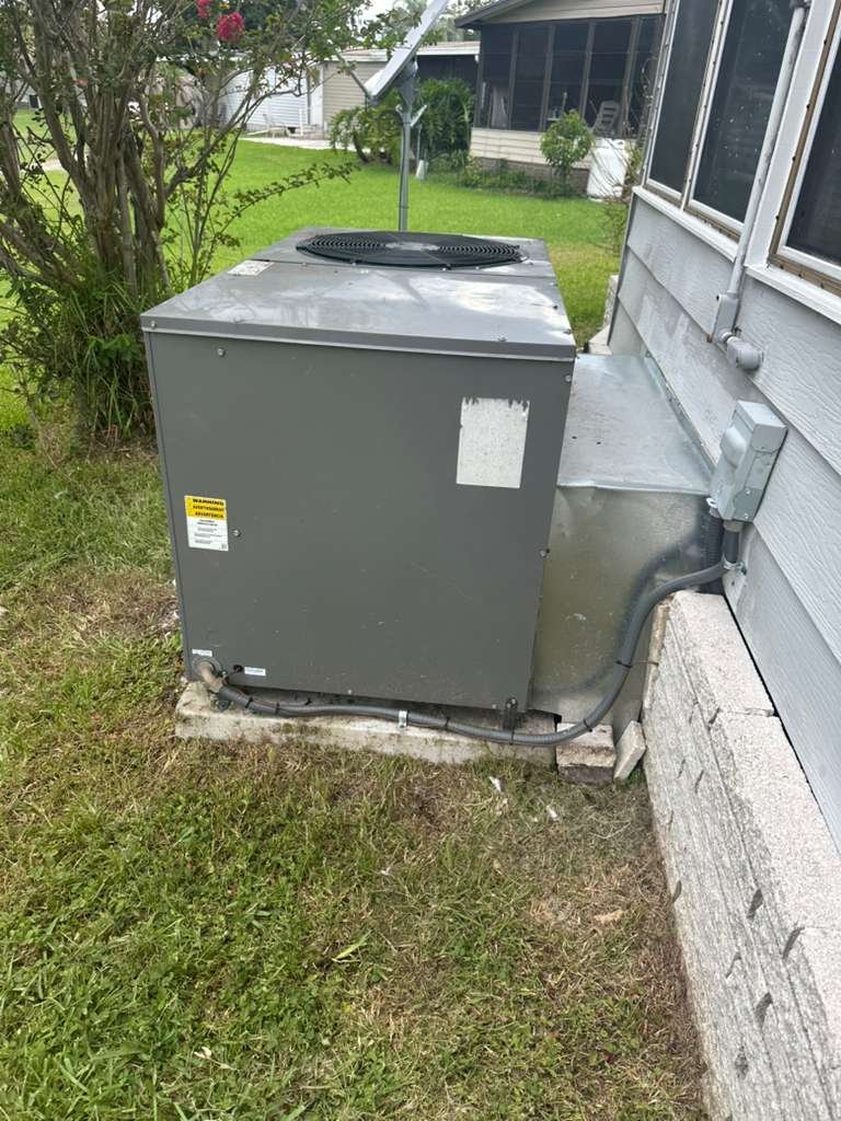 Newly installed outdoor AC unit with surrounding area in Plant City, FL 33565.