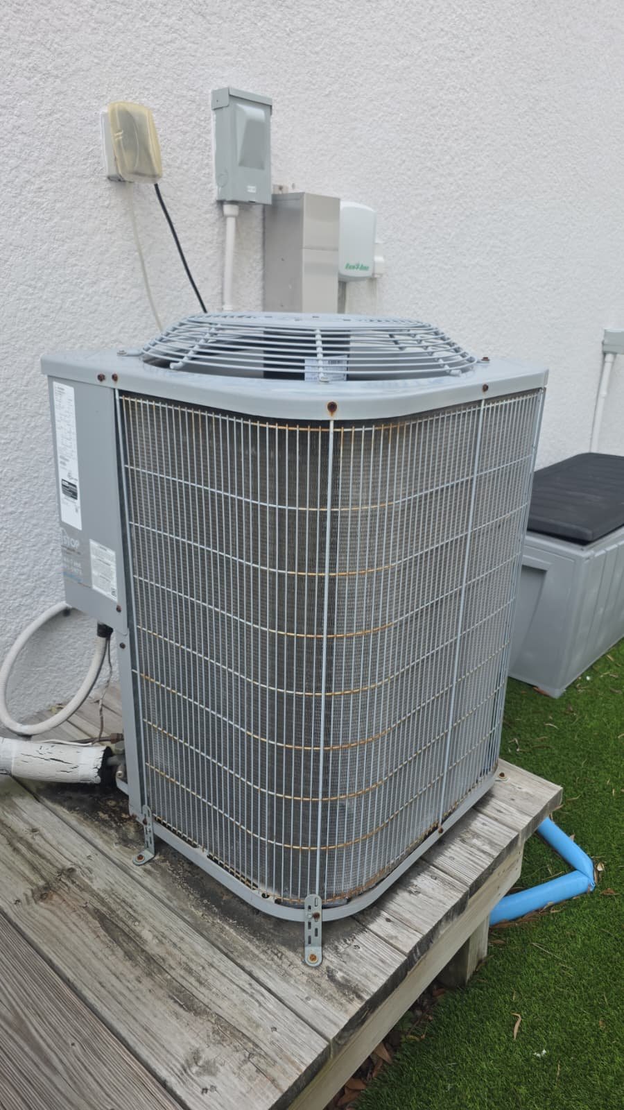 Outdoor AC Unit - Tampa, FL 33611 Outdoor AC unit on wooden platform beside house, Tampa, FL 33611.