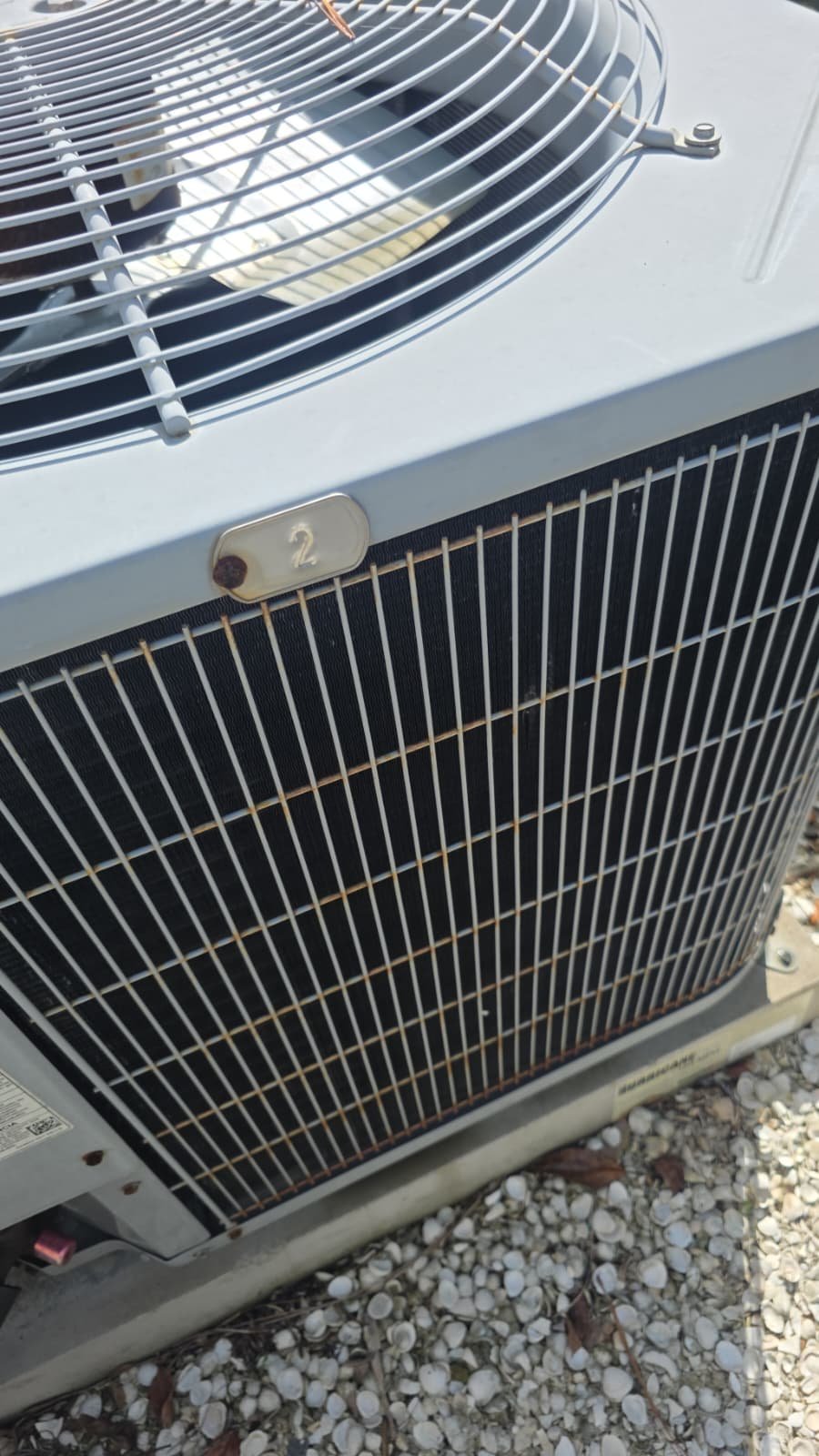 Outdoor AC Unit Top View - Tarpon Springs, FL 34688 Top view of an outdoor air conditioning unit with visible fan in Tarpon Springs, FL 34688. Efficient cooling solution.