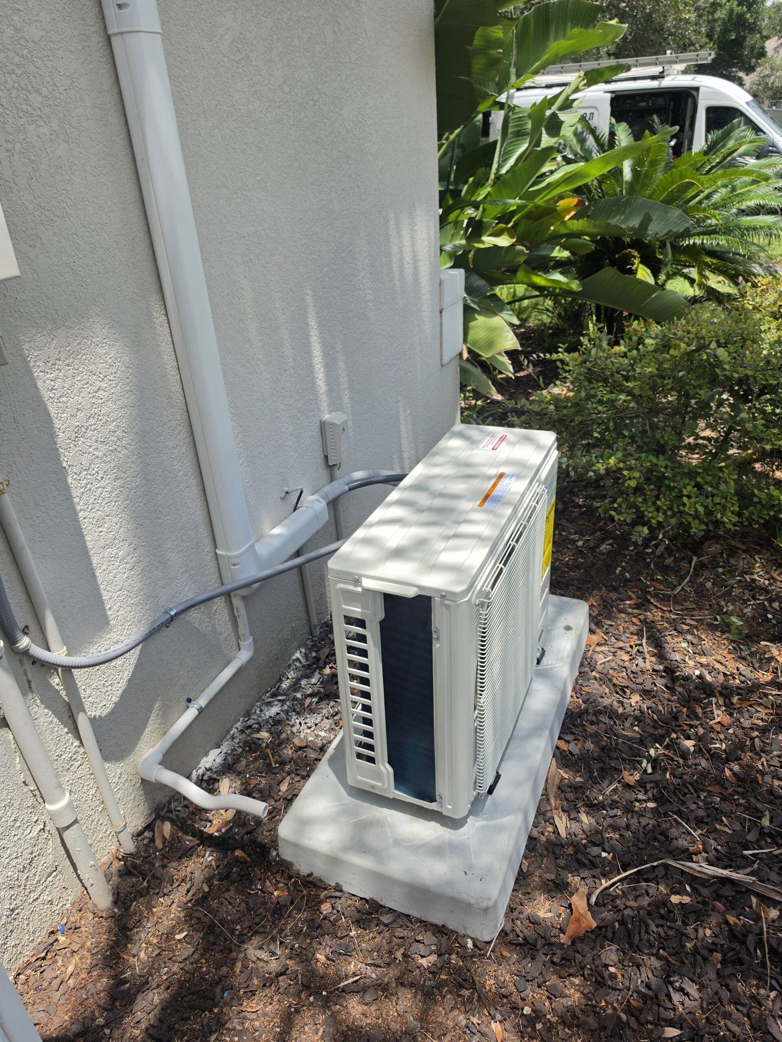 Mini split AC outdoor unit installed beside house, Lutz, FL 33558.